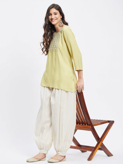 Off-white embellished silver self design Afghani salwar with elasticated waistband and drawstring.