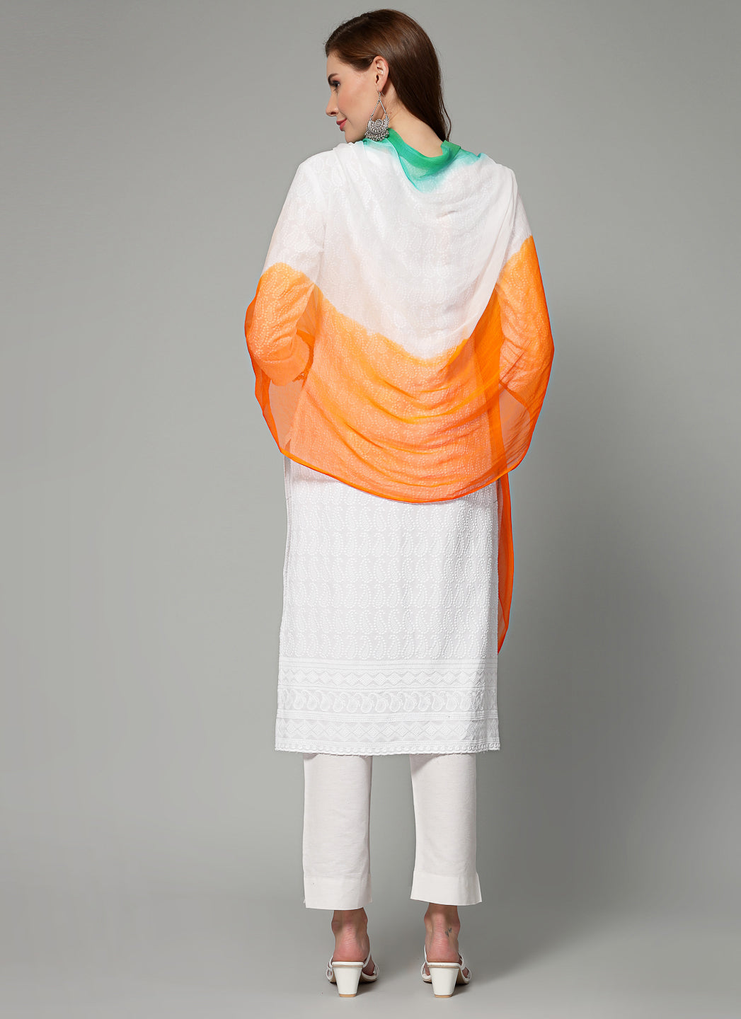 Women wearing a tri-colour dyed chiffon dupatta with pom pom border.