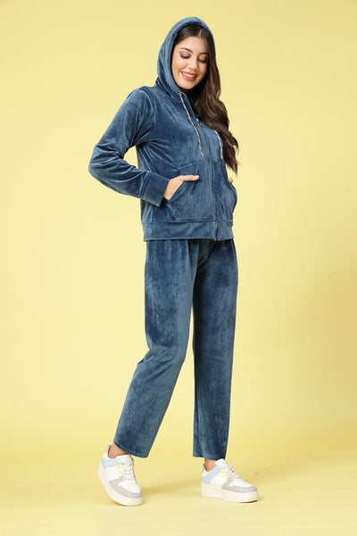 Women wearing a solid hooded velvet co-ord set with long sleeves and zip closure.