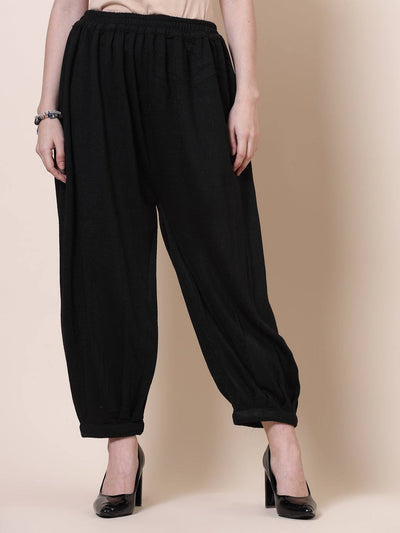 Black solid woolen Afghani salwar with elasticated waistband.