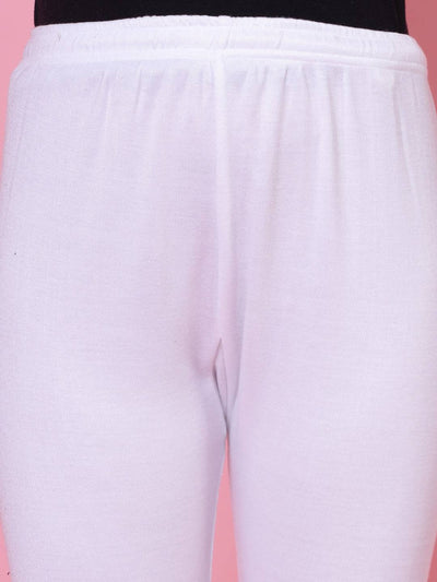 White and grey solid woolen leggings with elastic waistband and drawstring closure.