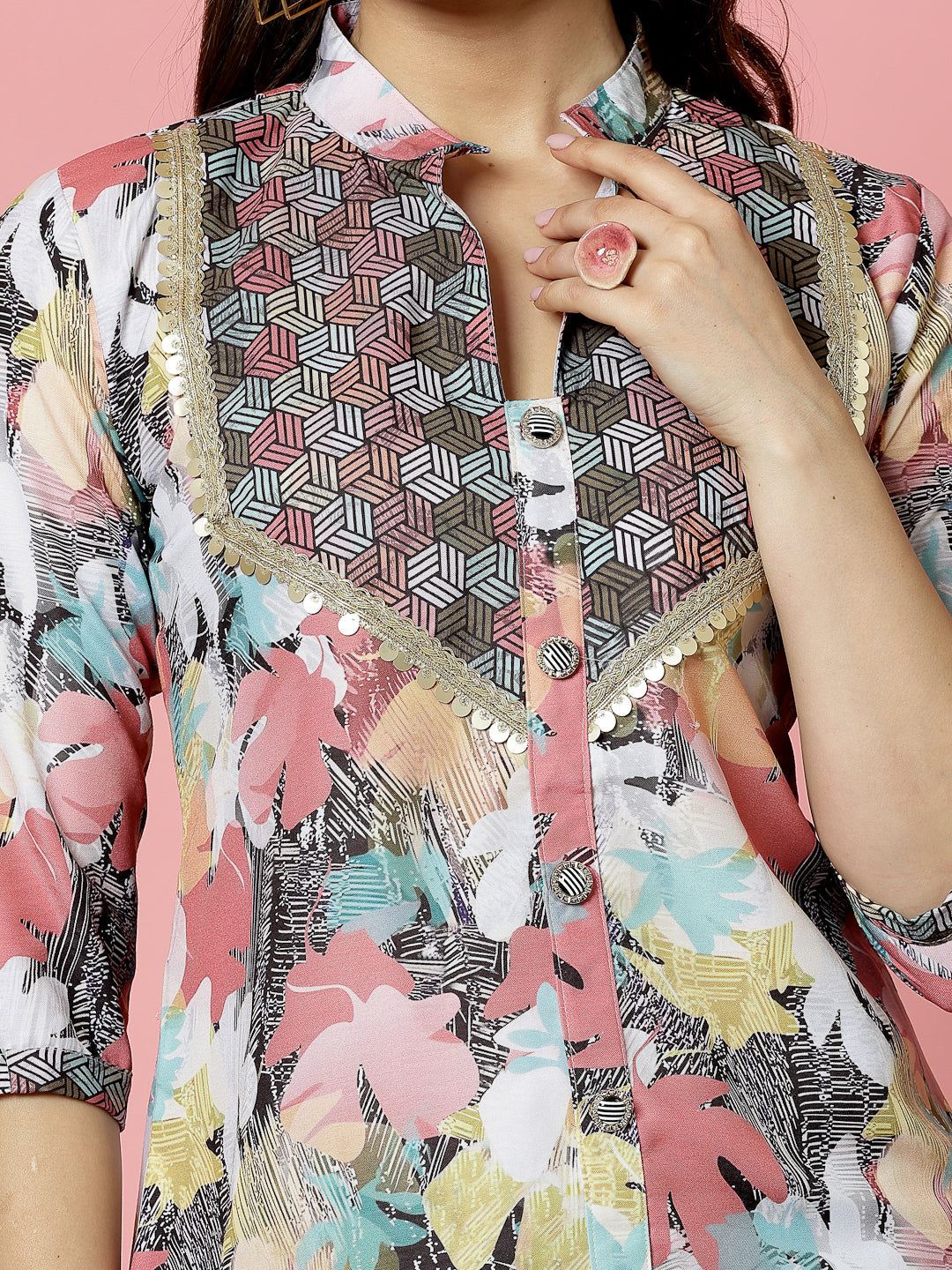 Floral printed embellished kurti with geometric design and three-quarter sleeves.