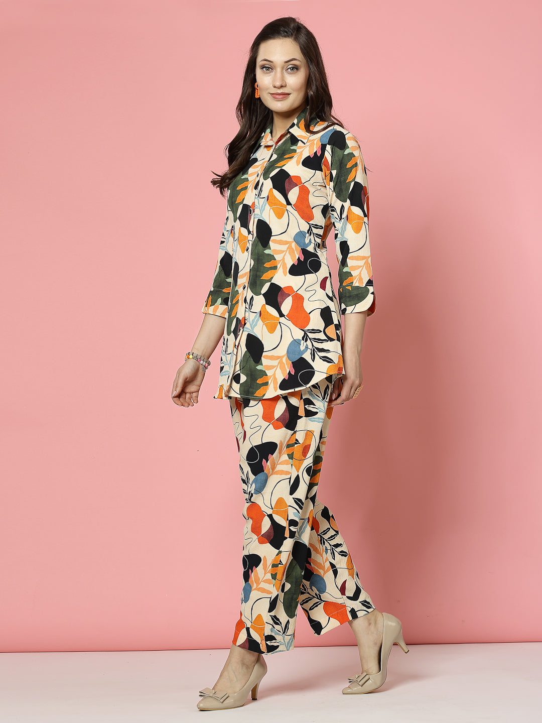 Floral digital printed shirt and trousers co-ords in orange and black with three-quarter sleeves.