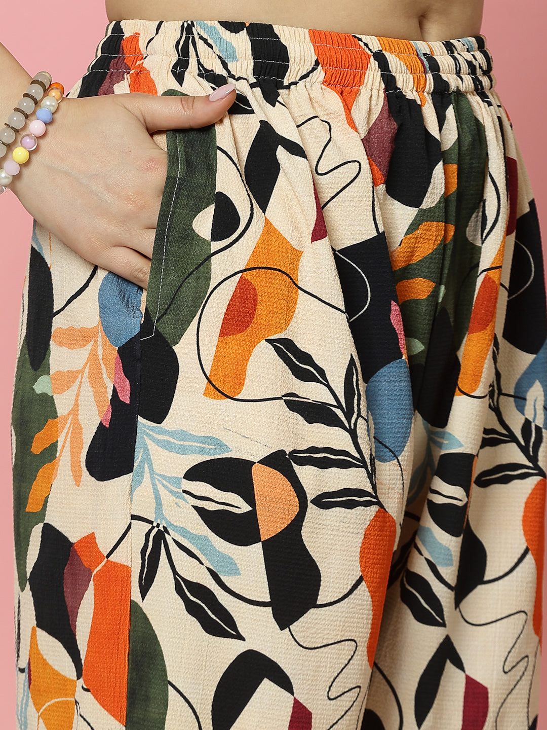 Floral digital printed trousers with orange and black pattern, elastic waistband, and straight fit.