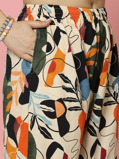 Floral digital printed trousers with orange and black pattern, elastic waistband, and straight fit.