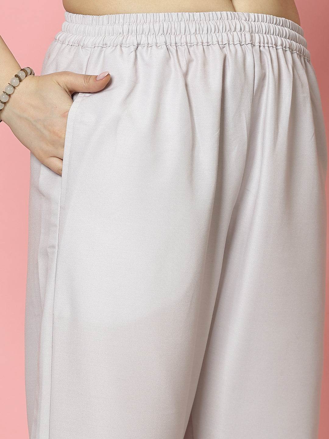 Light beige trousers with elastic waistband, part of the floral printed shirt collar kurta set.
