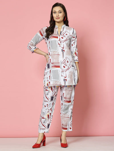 White abstract printed kurti and trousers set with geometric design, three-quarter sleeves, and V-neck.