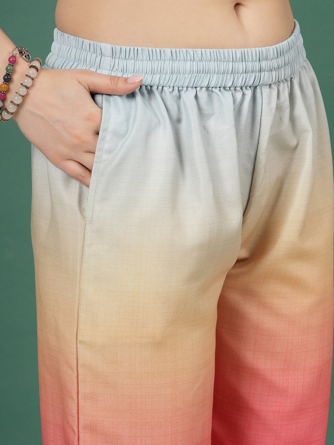 Light blue ombre design printed trousers with elastic waistband and pink gradient.