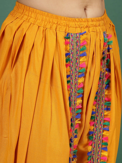 Embellished shirt collar kurti with mustard dhoti pants featuring colorful tassel detail.