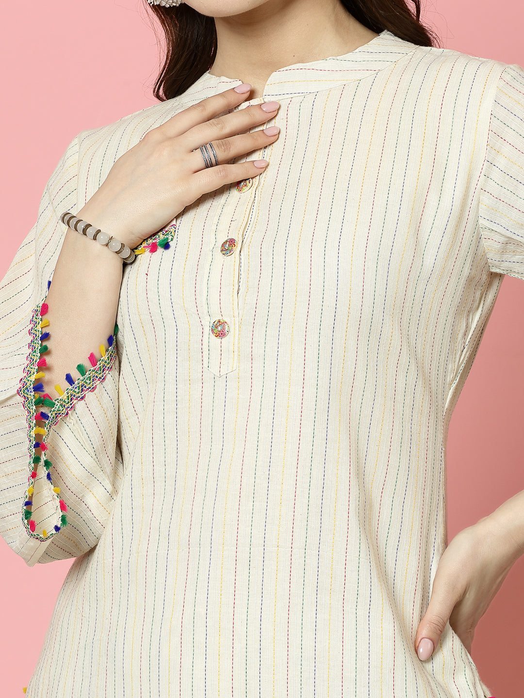 Kantha work mandarin collar kurti with three-quarter sleeves and button closure.