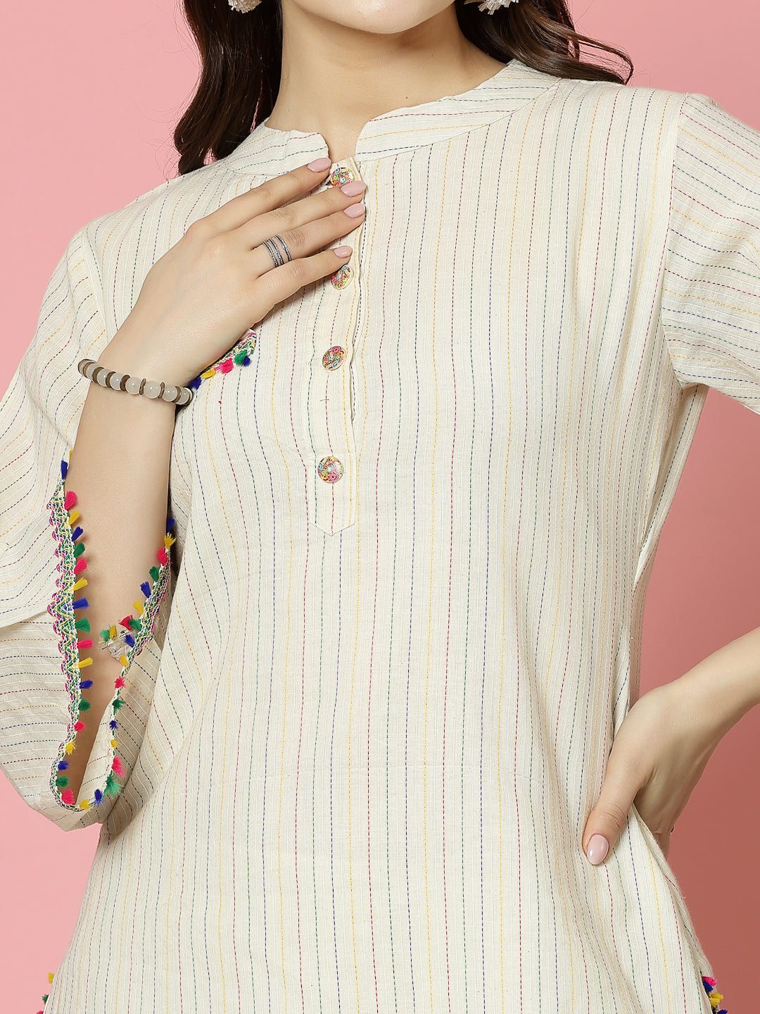 Kantha work mandarin collar kurti with button closure and colorful embellishments.