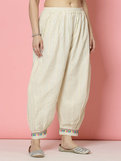 Kantha work loose fit Afghani salwar in cream cotton with colorful embroidered cuffs.