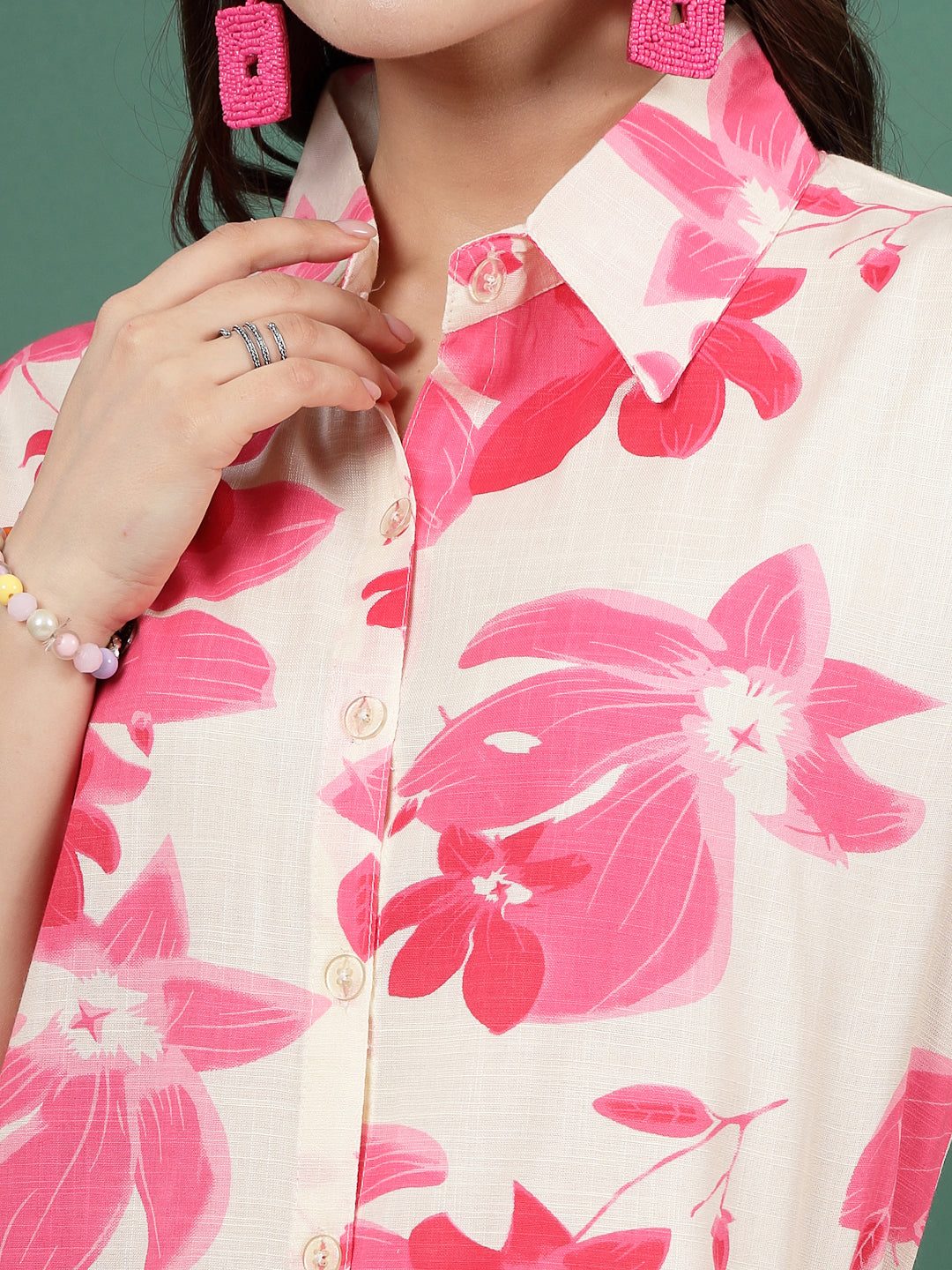 Floral printed shirt with pink flowers and button closure.