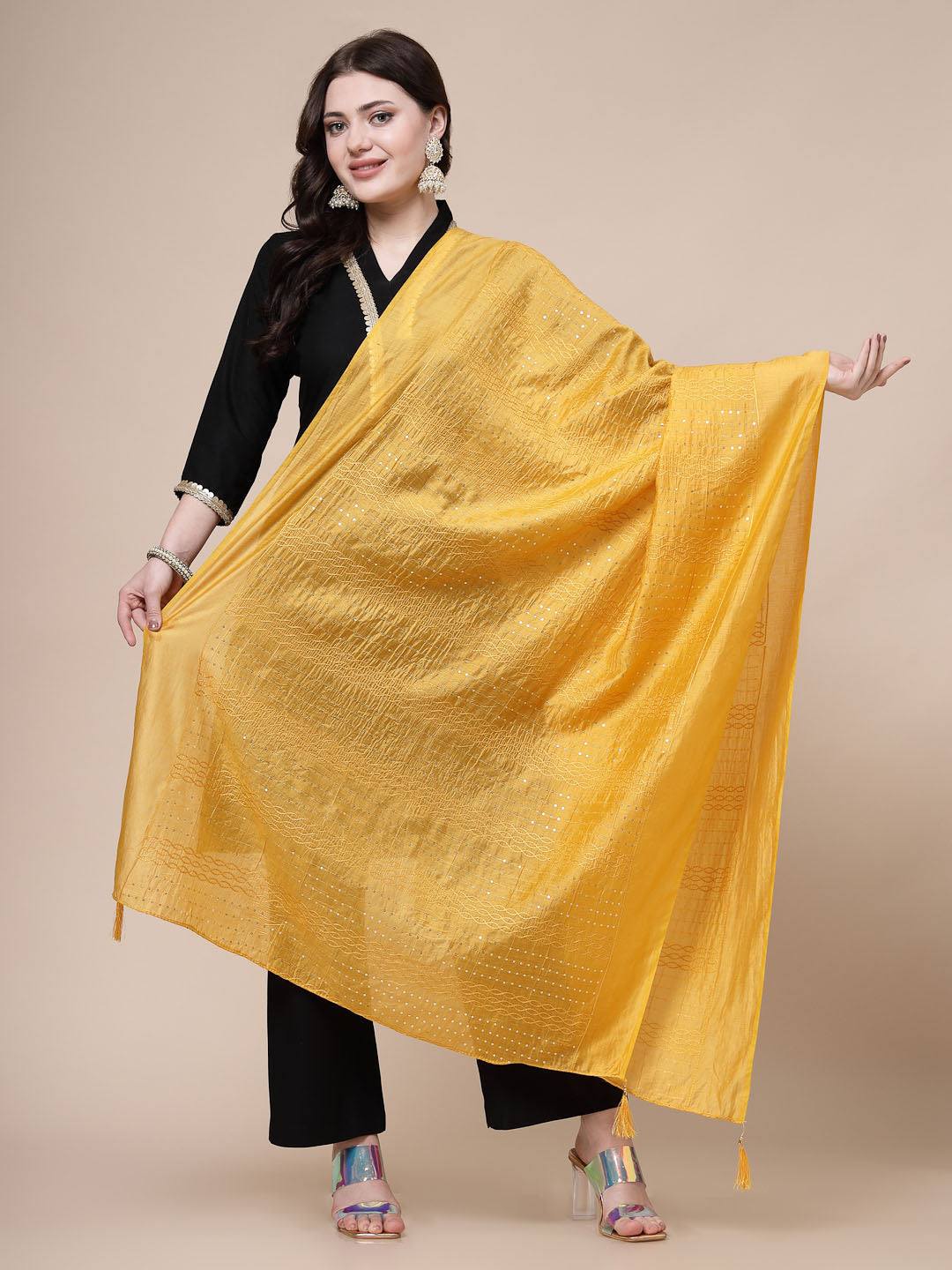 Mustard sequinned cotton dupatta with elegant design, styled by a model.