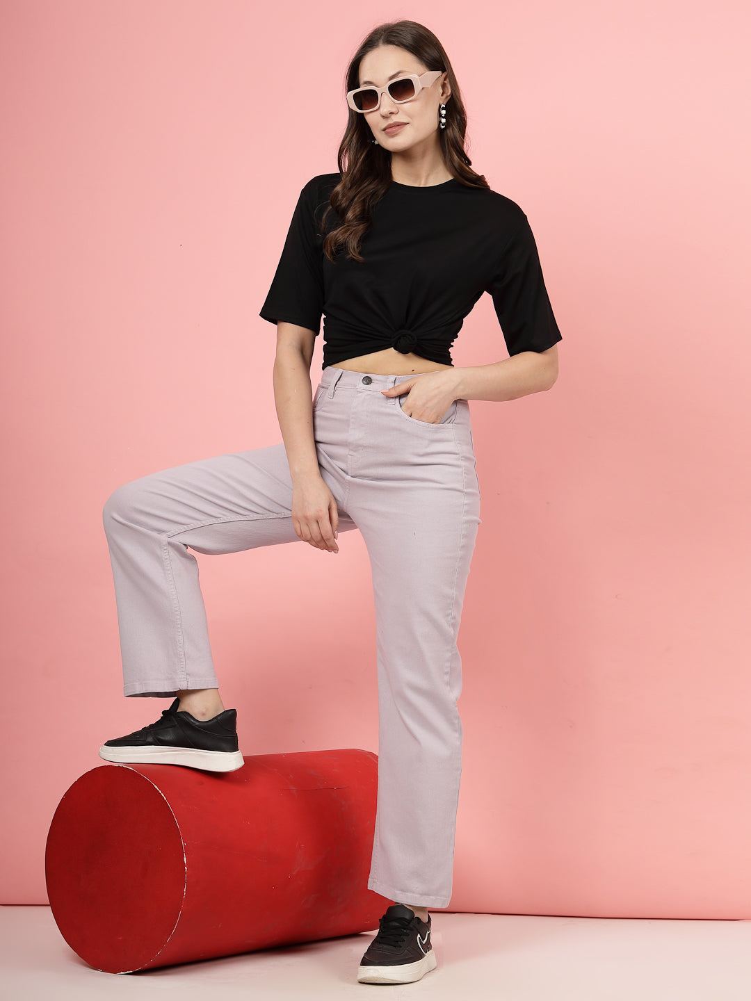 Black solid regular fit Tencel women's T-shirt styled with light-colored pants.