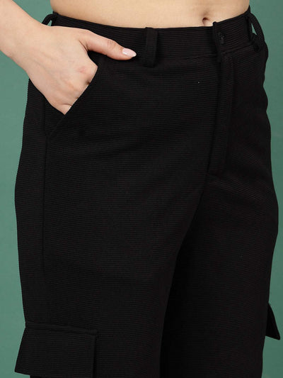 Black solid flat front mid rise corduroy cargo trousers.