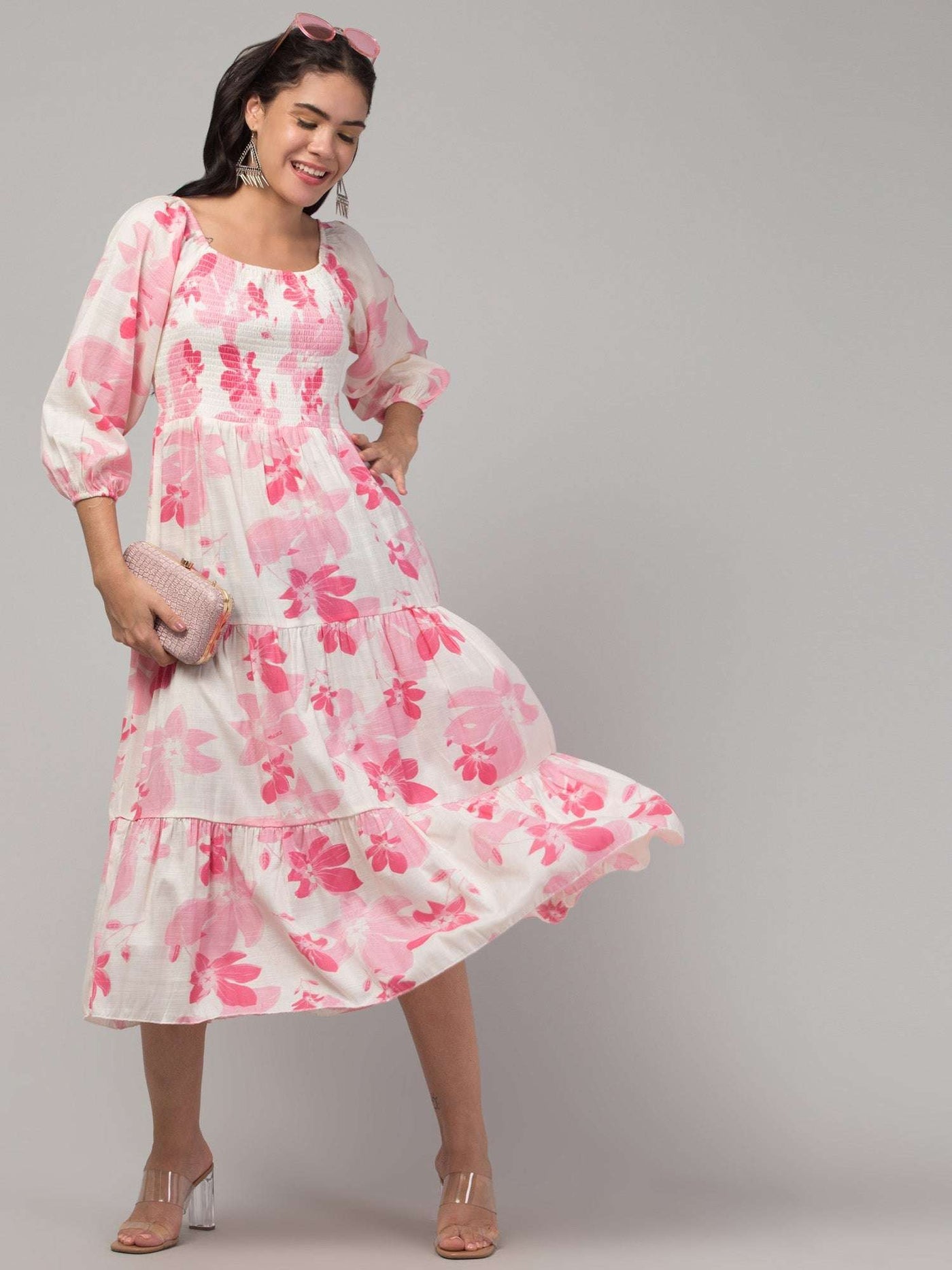 Women wearing a pink printed fit and flare dress made from viscose rayon, suitable for casual and semi-formal occasions.