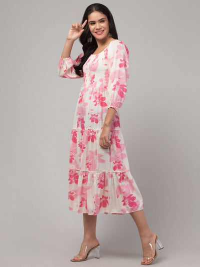 Women in a pink printed fit and flare dress made of viscose rayon, ideal for casual and semi-formal occasions.