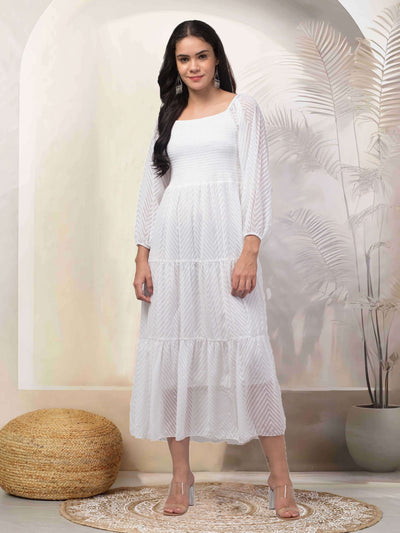 Women in white printed fit and flare dress made of Georgette fabric, ideal for casual and semi-formal occasions.