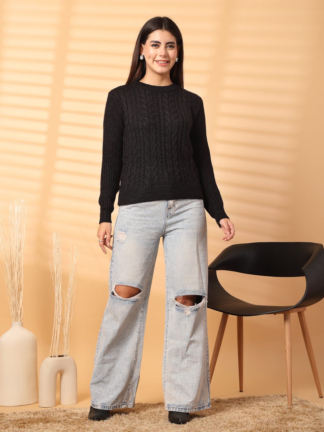 Black self-design woolen top with full sleeves, paired with ripped jeans.