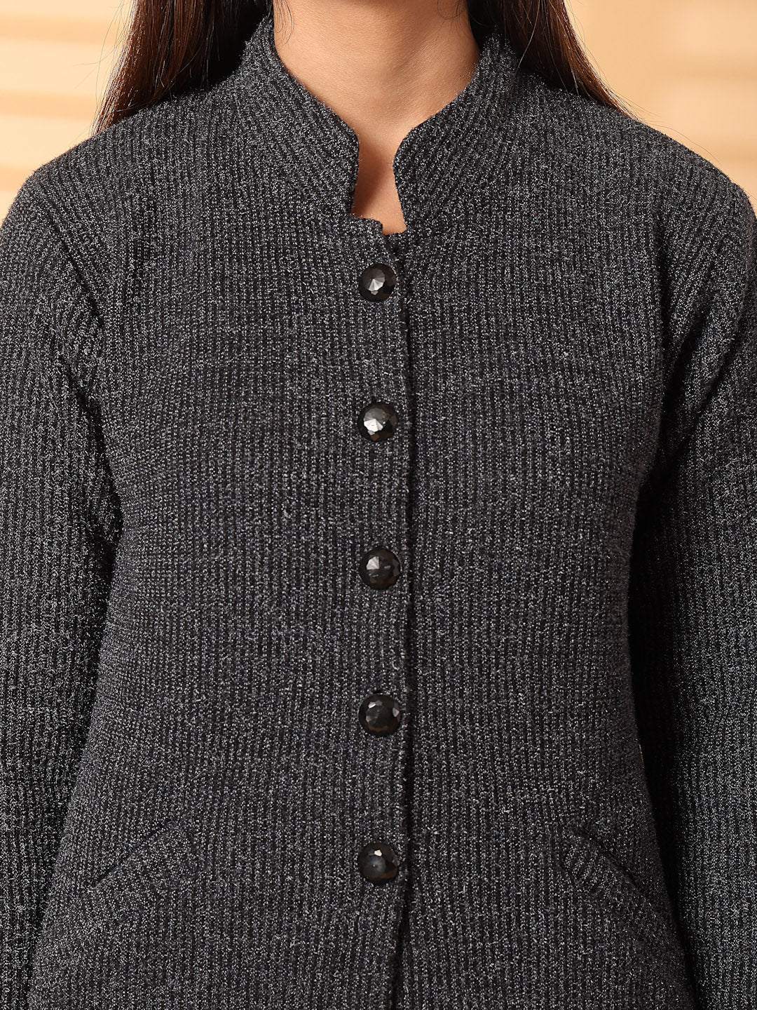 Black woolen knitted cardigan with full sleeves and button-up design.