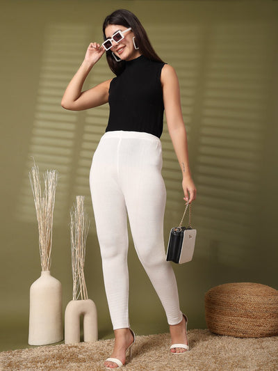 Women wearing white solid woolen leggings with hem design.