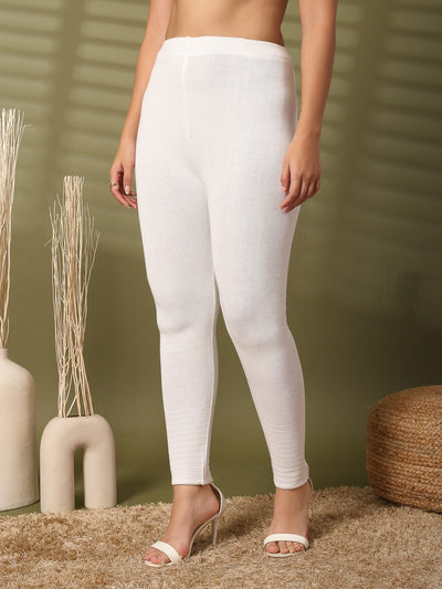 Women white solid woolen leggings with chic hem design.