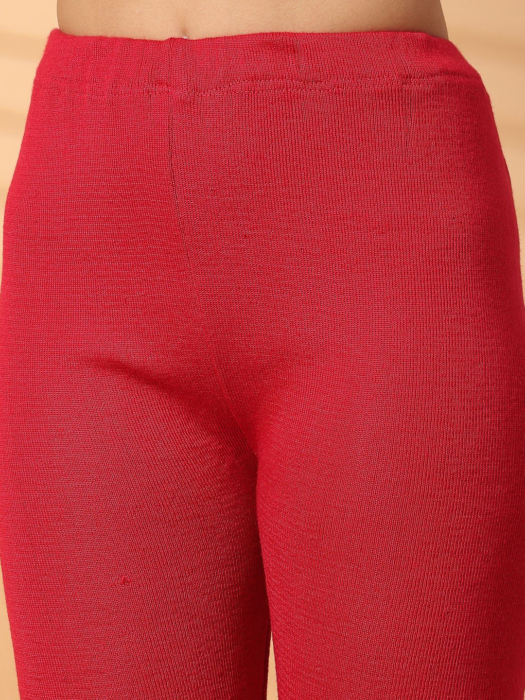 Women magenta solid woolen leggings with a unique hem design, offering a snug and comfortable fit.