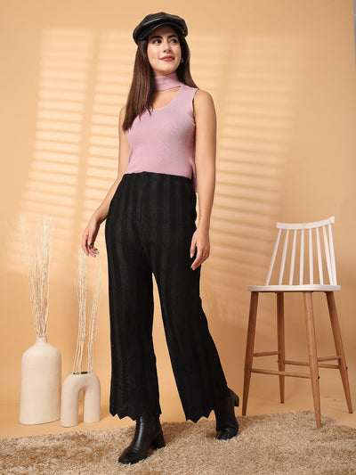 Black woolen palazzo with intricate cut work detailing at hemline.