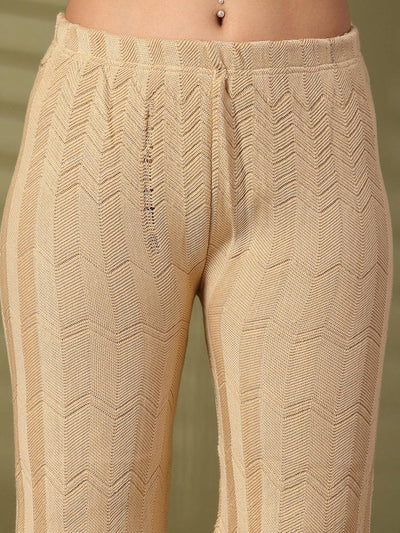 Beige solid cut work woolen palazzo with detailed hemline.