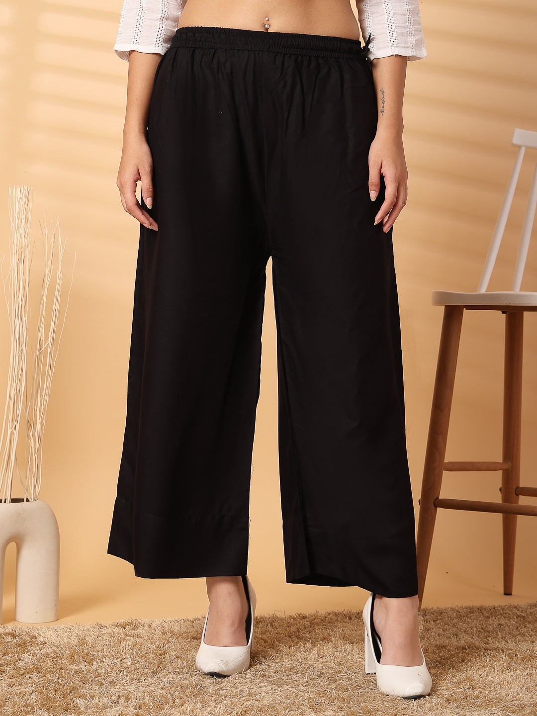 Black solid rayon straight palazzo with wide leg and elastic waistband.