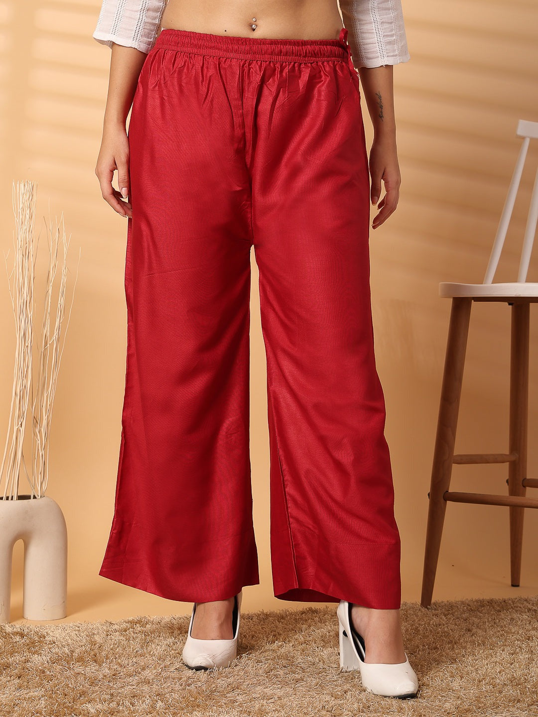 Red solid rayon straight palazzo with elasticated waistband and wide-leg fit.