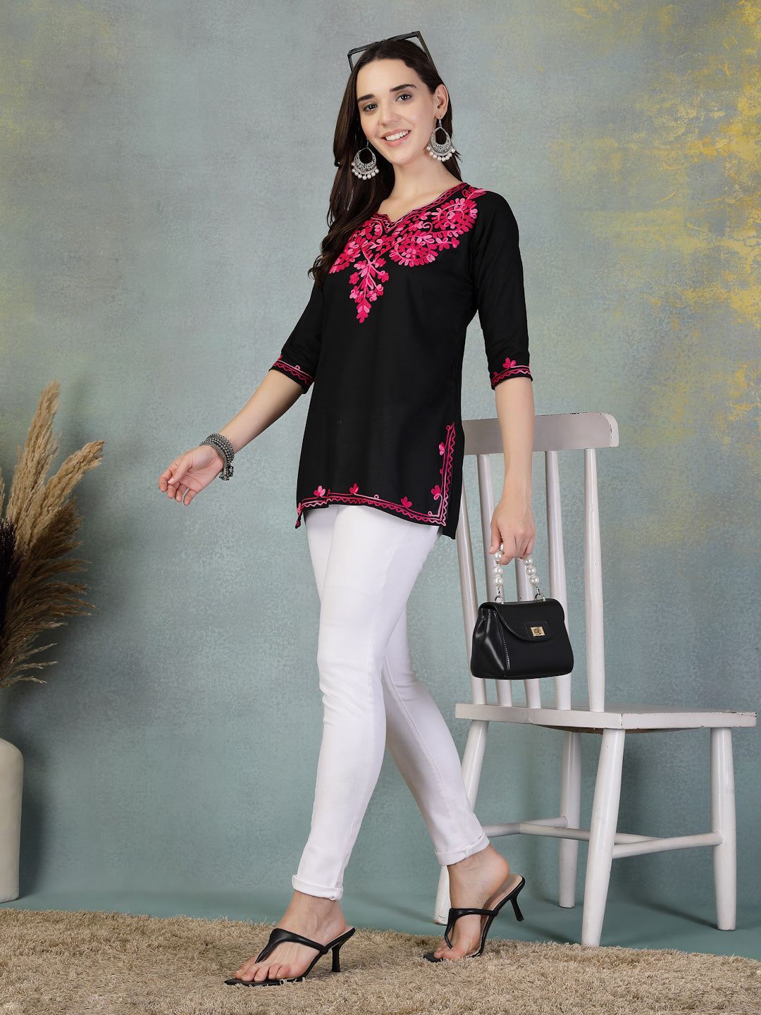 Black embroidered rayon kurti paired with white leggings worn by a woman holding a black handbag