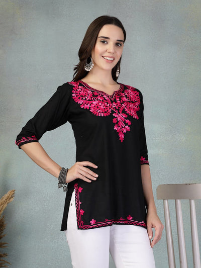 Black embroidered rayon kurti with pink floral embroidery, styled with white pants, perfect for casual or office wear