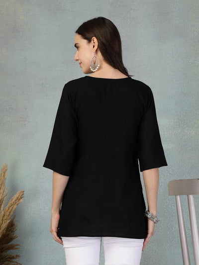 Black embroidered rayon kurti with three-quarter sleeves worn with white pants back view