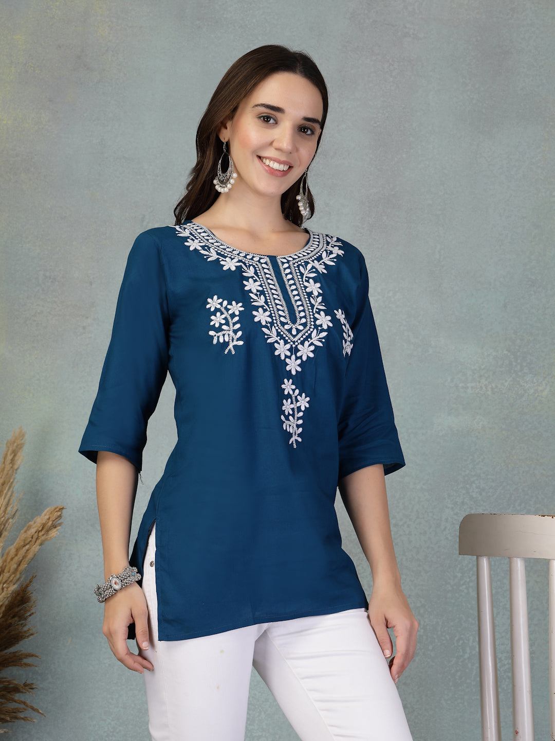 Peacock blue embroidered rayon kurti with three-quarter sleeves styled with white pants