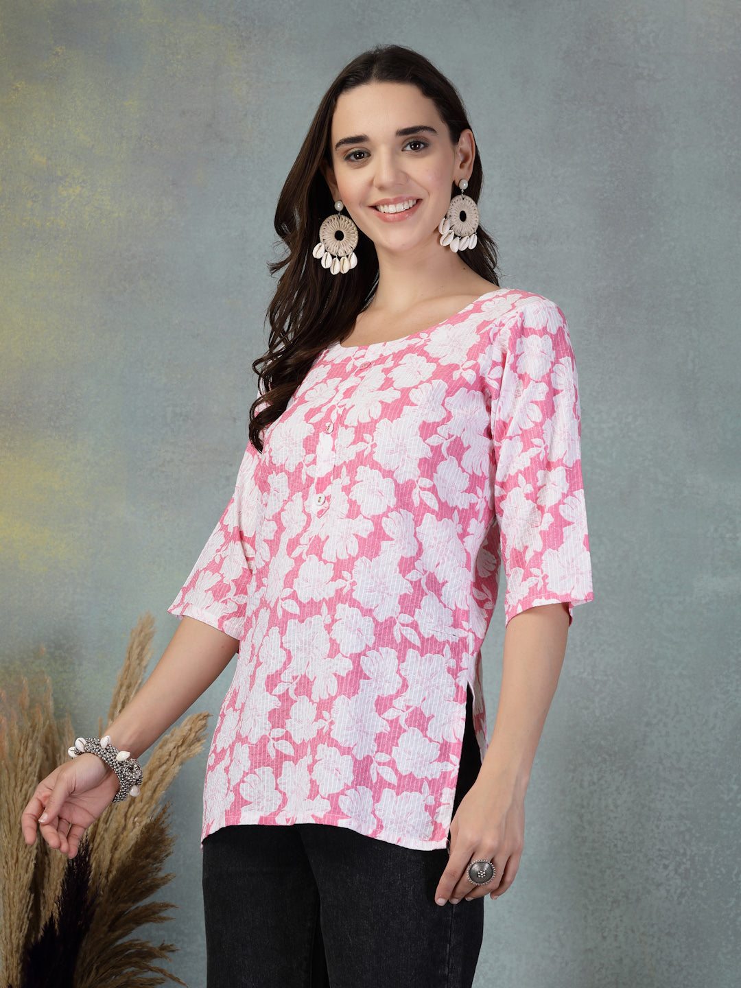 Woman wearing pink Kantha work printed cotton kurti with floral design and three-quarter sleeves