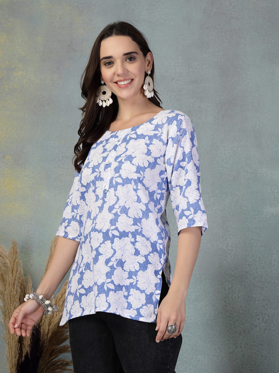 Blue Kantha Work printed cotton kurti with floral design and three-quarter sleeves worn by smiling woman