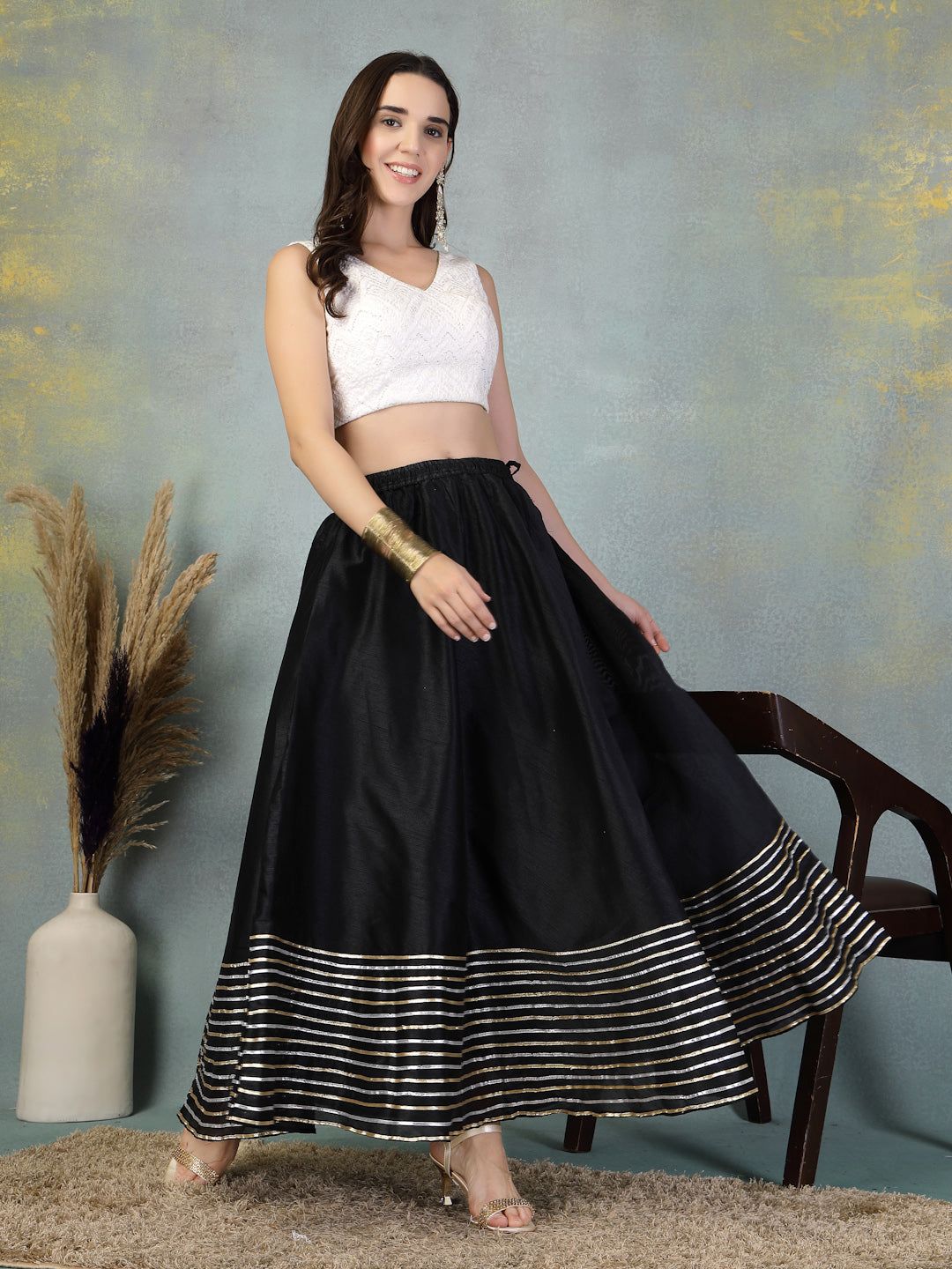 Black Gotta Patti Chanderi silk flared skirt with gold border detail worn with white crop top