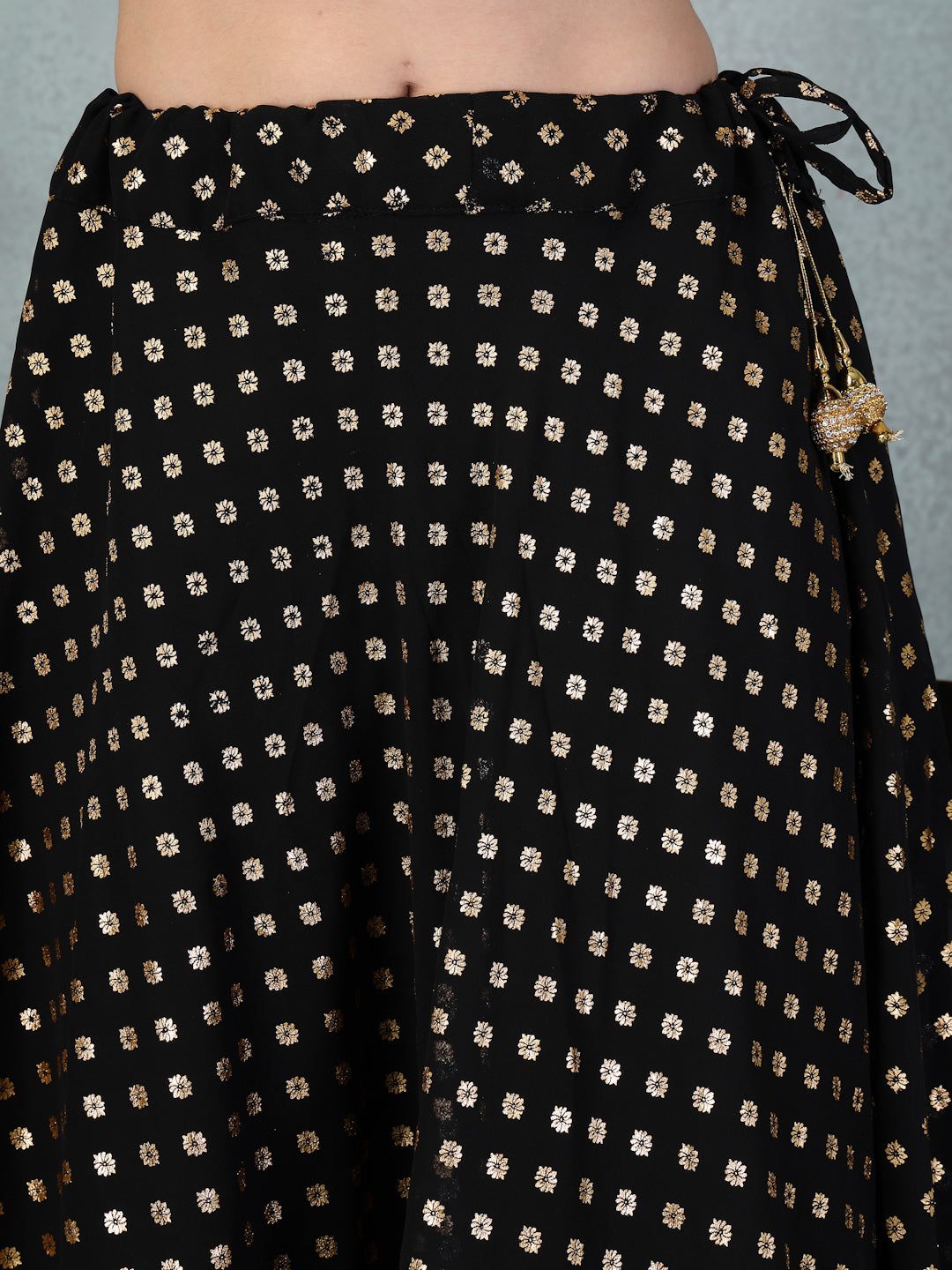 Black printed georgette skirt with matching dupatta, featuring elegant foil patterns for festive occasions.