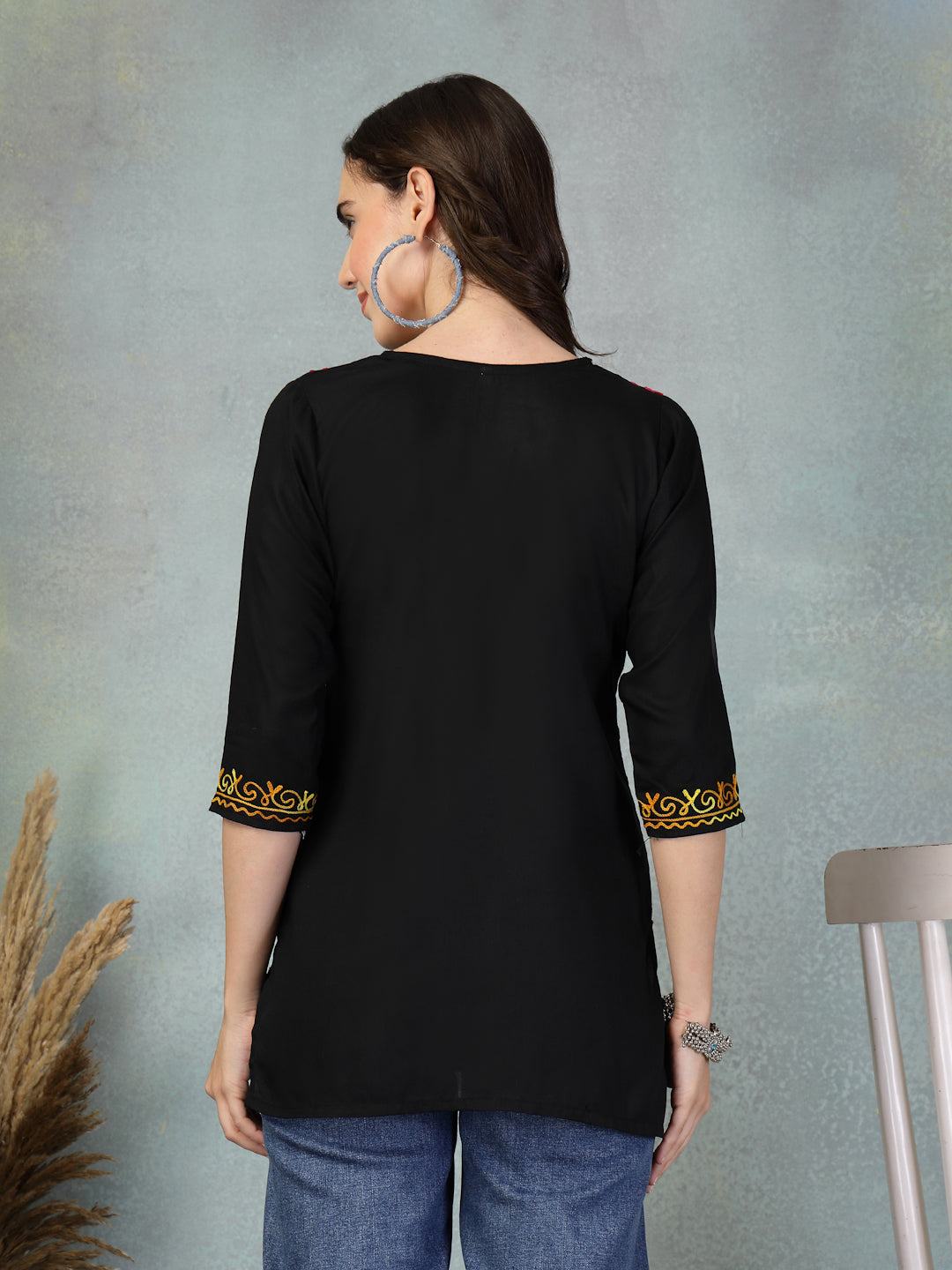 Back view of black embroidered rayon kurti with gold detailing on sleeves paired with jeans