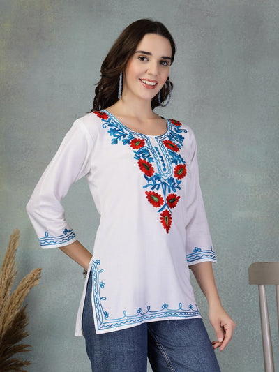 White embroidered rayon kurti with red and blue floral embroidery paired with jeans