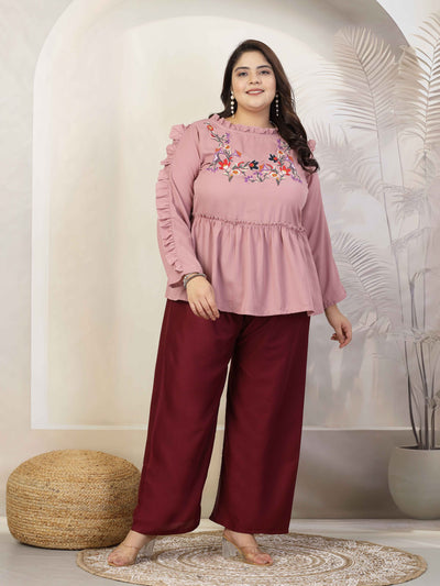 Plus size women wearing wine-colored rayon palazzo with elasticated waistband.
