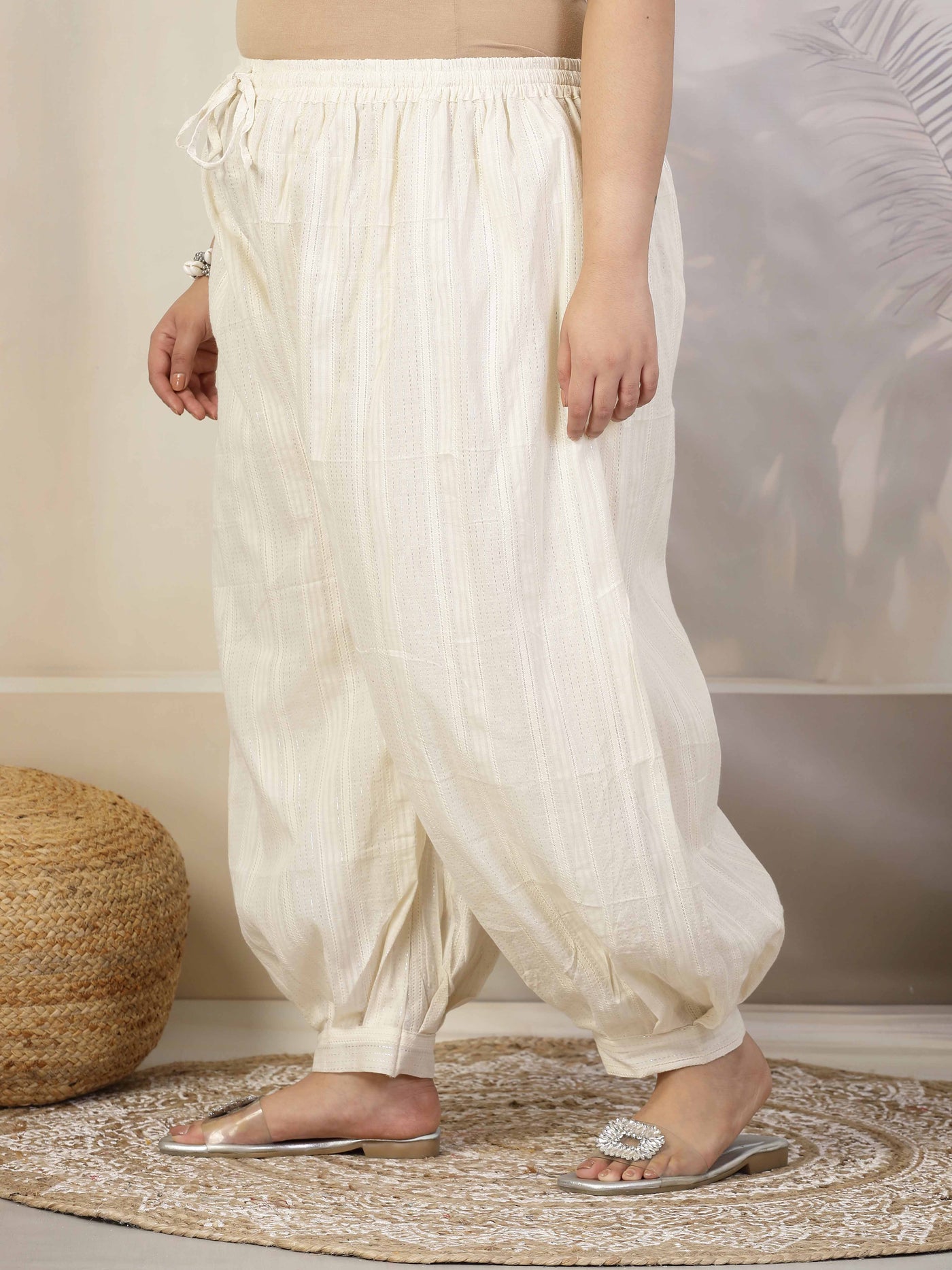 Women self design cotton lurex loose fit Afghani salwar with elasticated waistband and drawstring closure.
