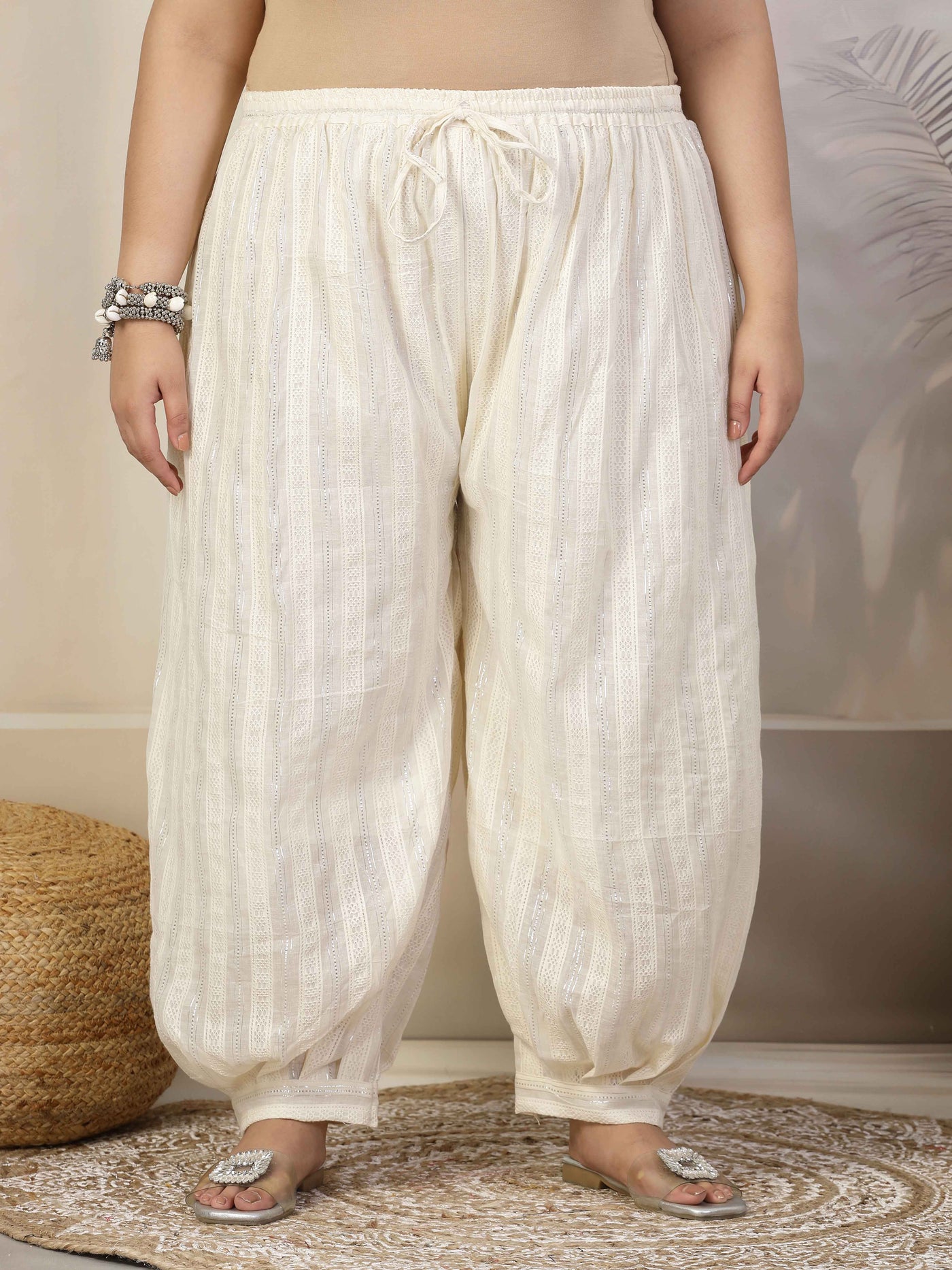 Women self design cotton lurex loose fit Afghani salwar with elasticated waistband and drawstring closure.