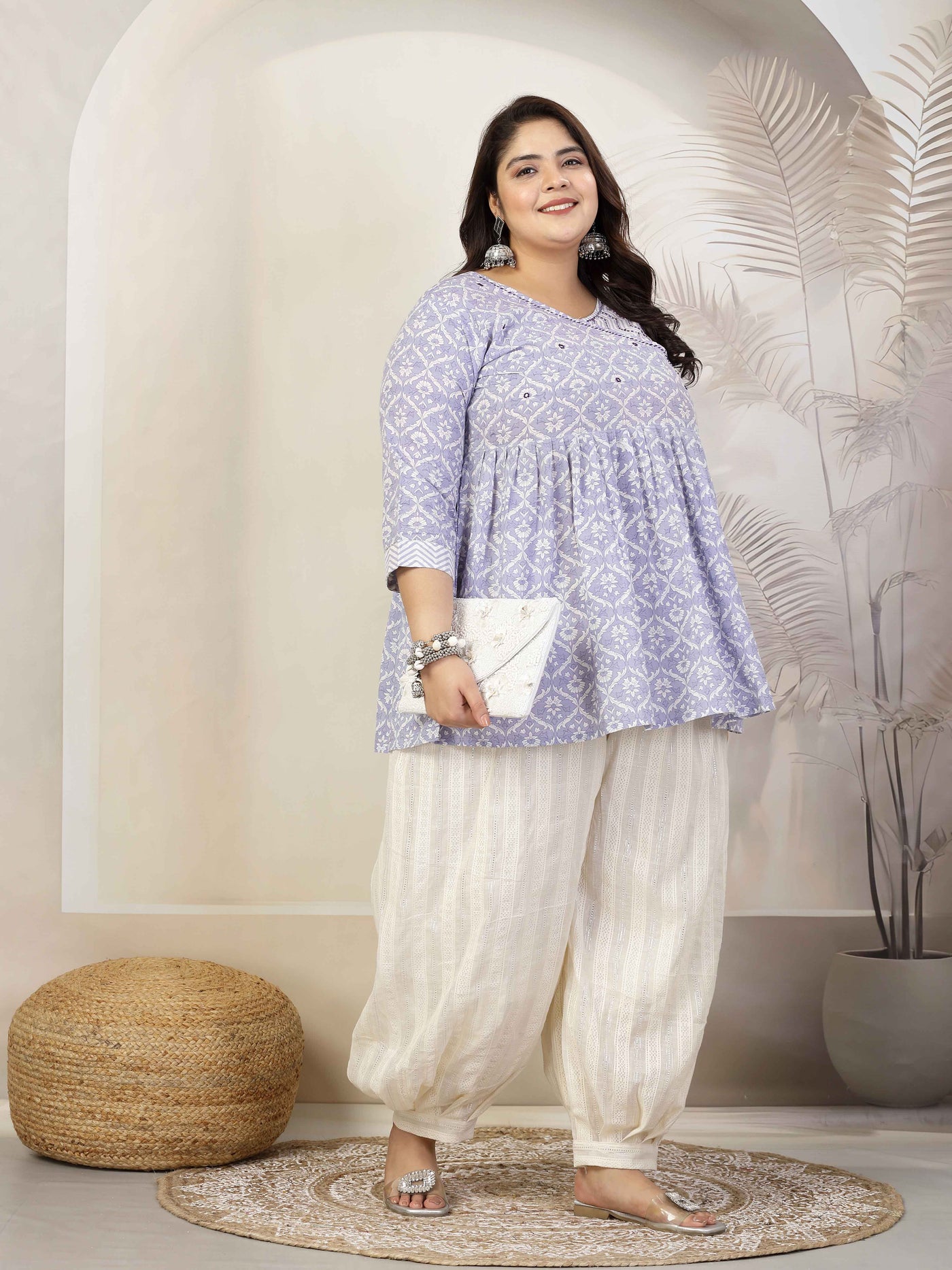 Woman wearing cotton lurex loose fit Afghani salwar with elasticated waistband and drawstring closure.
