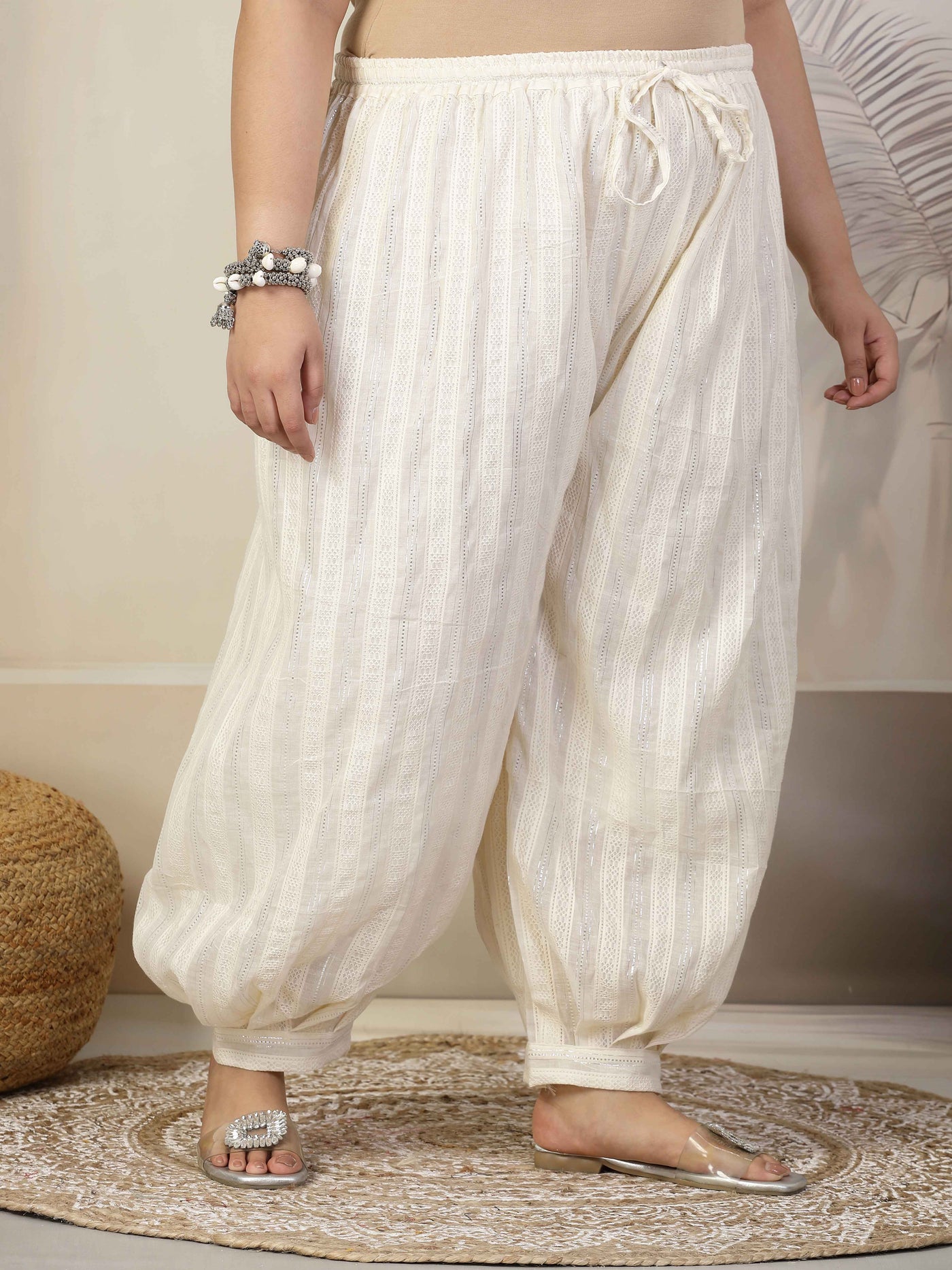 Women self design cotton lurex loose fit Afghani salwar with elasticated waistband and drawstring closure.