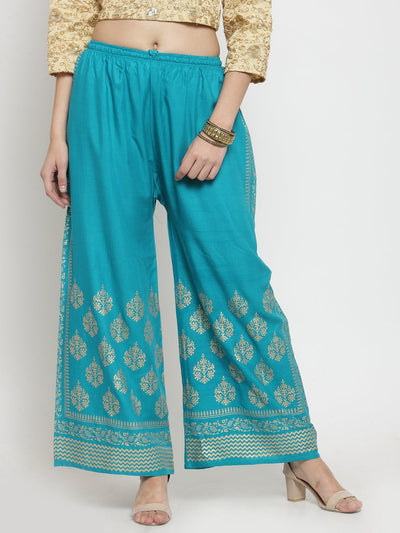 Turquoise printed rayon palazzo pants, elegant design, paired with formal shirt.