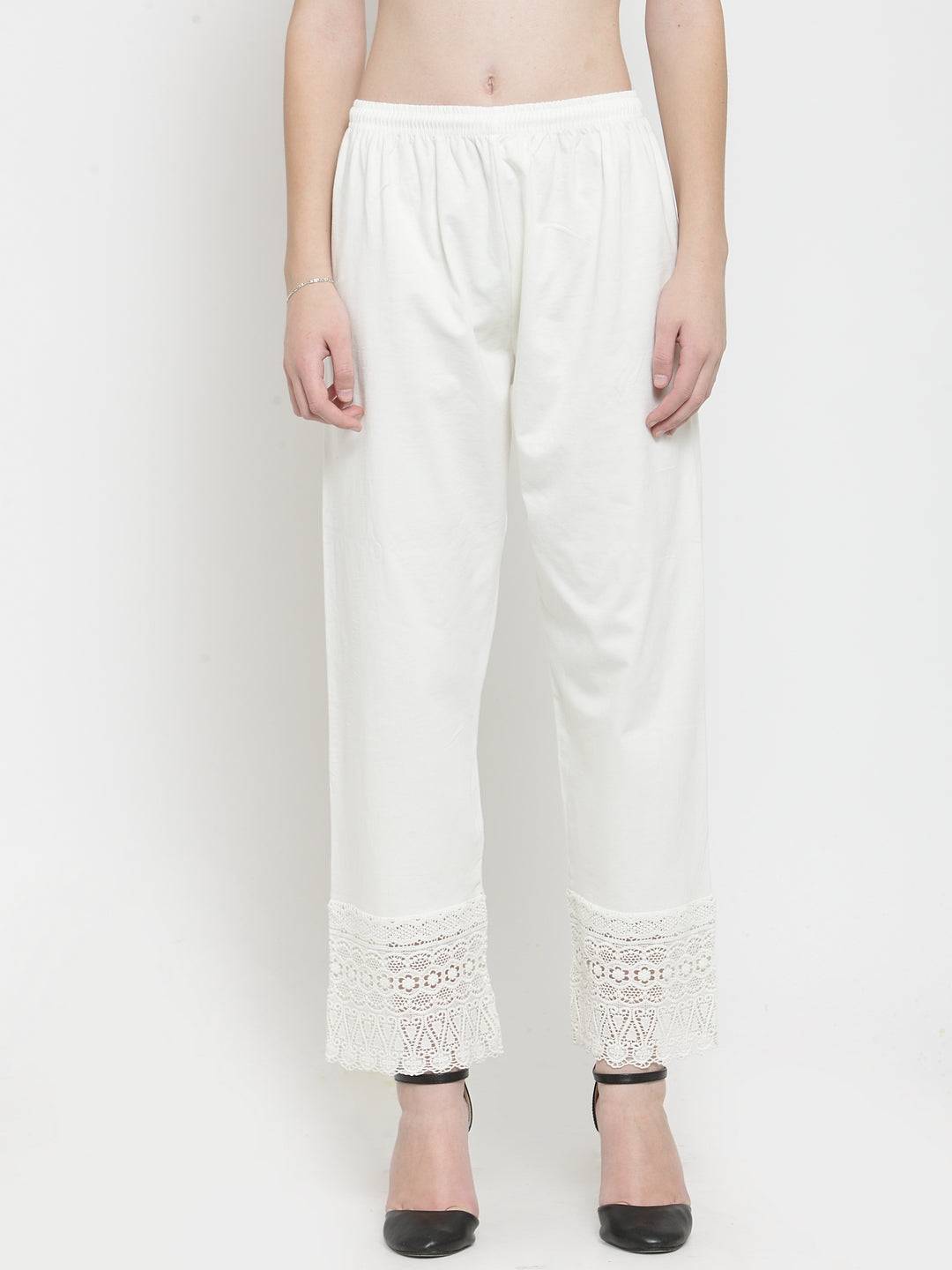 Off-White Viscose Lace Palazzo with lace detail at the hem, paired with black heels.