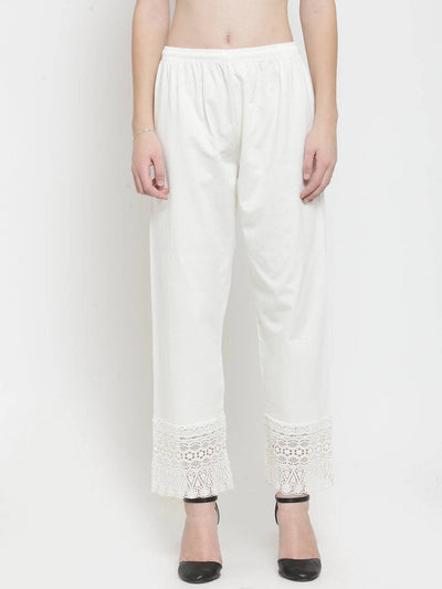Off-White Viscose Lace Palazzo with lace detail at the hem, paired with black heels.